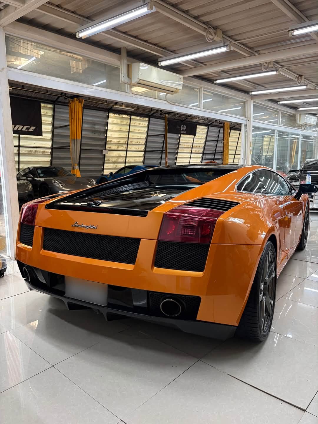 Orange Lamborghini Gallardo at Doctor Auto Performance after suspension work