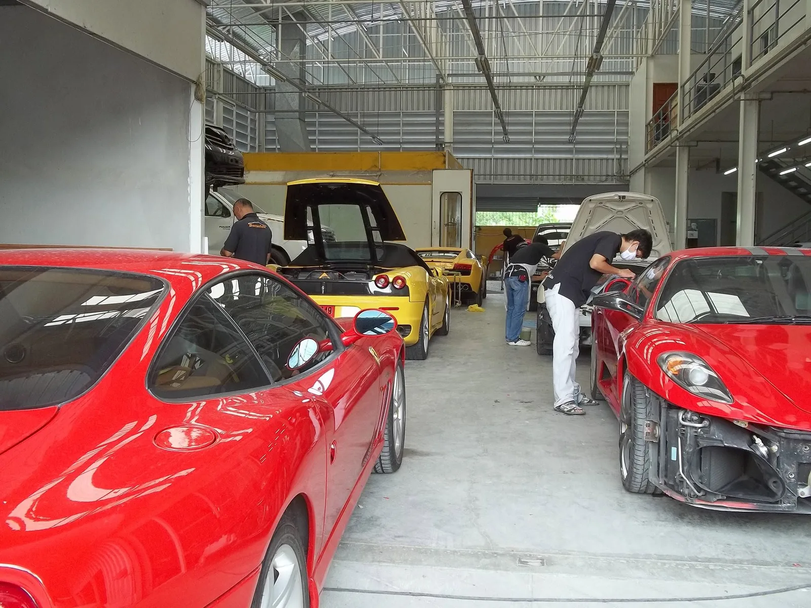 Maserati สีน้ำเงินและ Ferrari 599 สีแดงในศูนย์บริการ Doctor Auto Clinic